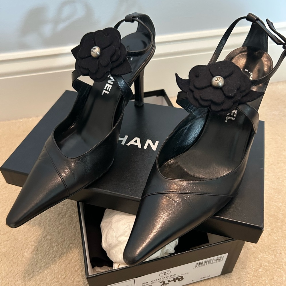 CHANEL Black Leather Pointed Toe Slingback Heels with Camellia Accent